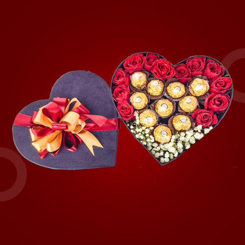 Amused Sweets Box featuring 12 red roses, 10 Ferrero Rocher chocolates, and Gypsophila Baby's Breath, arranged in a heart-shaped black box.