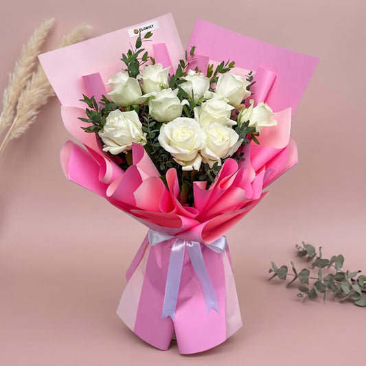 Brighten any moment with the Jaunty Flora Bouquet: 10 white China roses & eucalyptus parvi wrapped in two‑toned pink. Same‑day Metro Manila delivery.