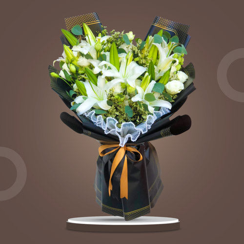 Stunning bouquet with white stargazer lilies, lisianthus, golden rods, and eucalyptus leaves in Korean-style wrap with satin ribbon - enchanting flower arrangement for special occasions - flower delivery to Ayala Museum and Poblacion, Makati