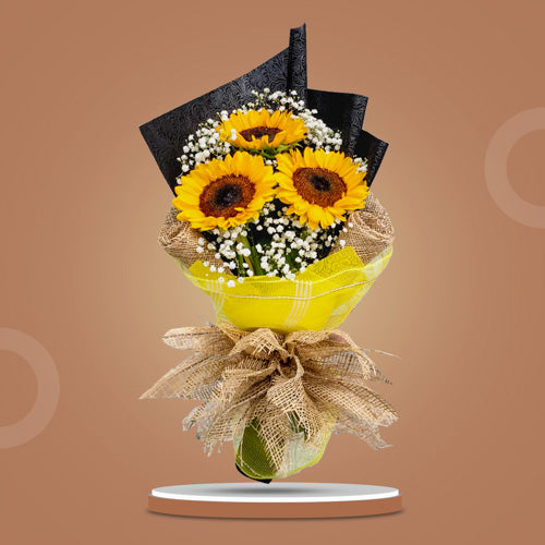 Sunny trio: Bouquet featuring 3 sunflowers and delicate Gypsophila fillers, wrapped in tissue paper, burlap, and net for a rustic touch of charm. Perfect for delivery to SM Megamall and SM City North EDSA.