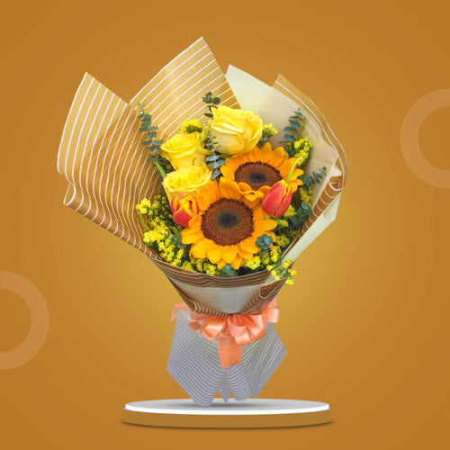 Summer Yellow and Orange Bouquet featuring two vibrant sunflowers, three yellow Ecuadorian roses, two tulips, statice, and eucalyptus, wrapped in a rustic and elegant presentation.