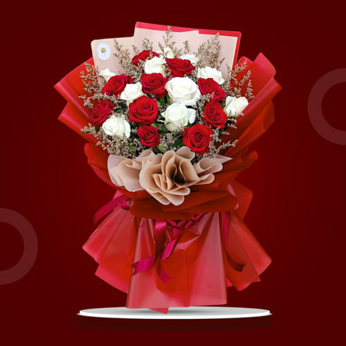 Captivating Bouquet of Red and White Roses complemented by delicate Misty Blue Fillers, beautifully arranged in a Korean-style wrap and adorned with a luxurious Satin Ribbon.