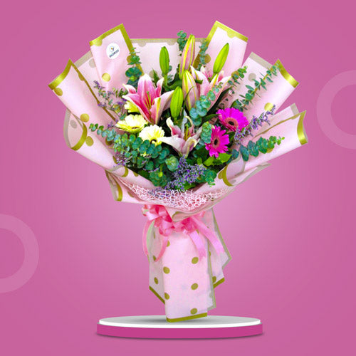 Unending Love Bouquet featuring stargazers, white and pink gerberas, misty blue flowers, and eucalyptus leaves in a captivating floral arrangement.