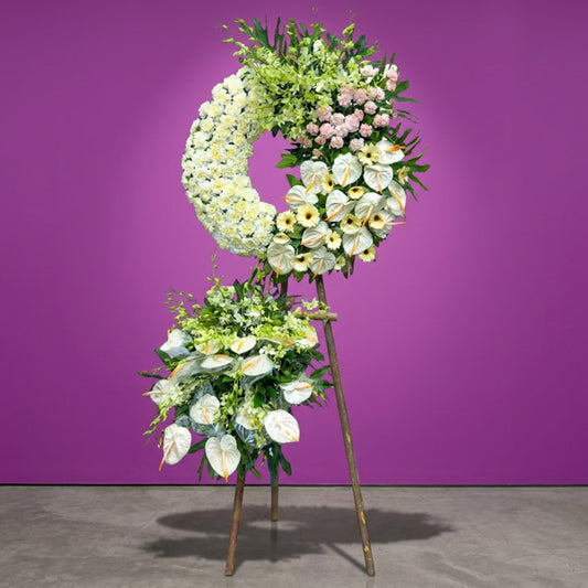 Above Memory Funeral Stand with white and pink carnations, white gerbera daisies, orchids, and anthurium flowers