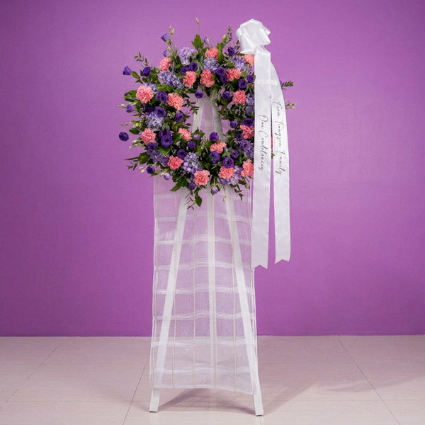 Purple lisianthus and hydrangea funeral stand with pink carnations
