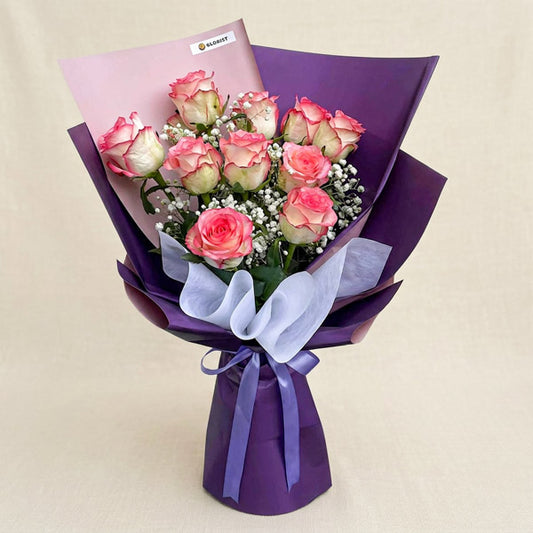 Affectionate Flora bouquet with 2‑toned light pink China roses and gypsophila baby’s breath in purple Korean wrap tied with a lavender ribbon