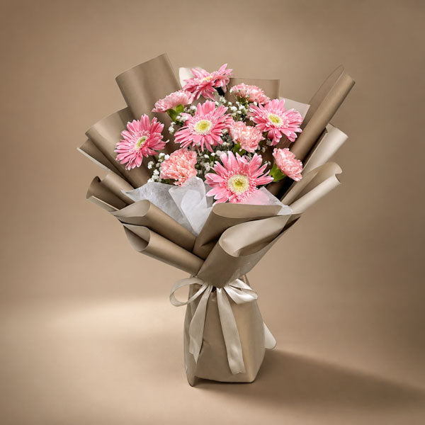 Amber Love bouquet with pink gerberas, carnations, baby’s breath and café wrap with latte ribbon