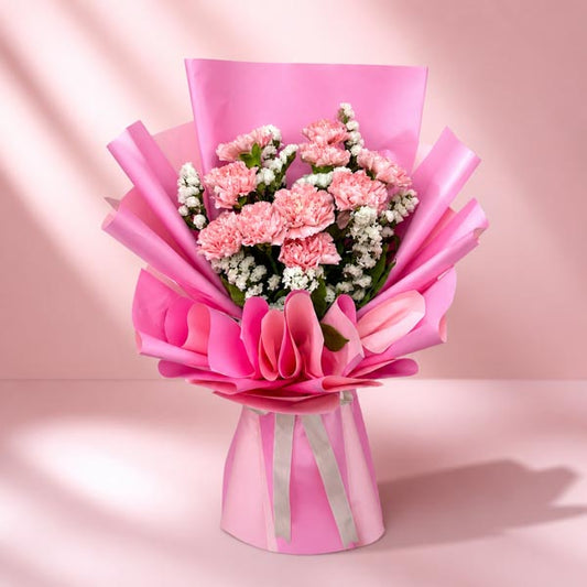 Amour Radiance bouquet with 10 carnations and white statice wrapped in two-toned pink Korean wrap with cream ribbon
