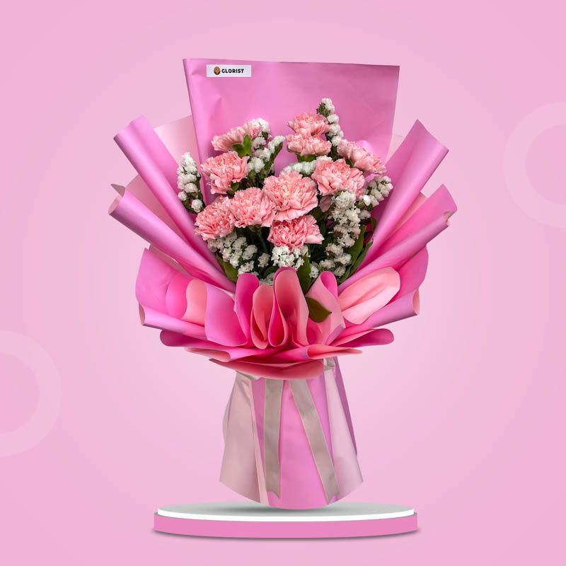 Amour Radiance bouquet with 10 carnations and white statice wrapped in two-toned pink Korean wrap with cream ribbon