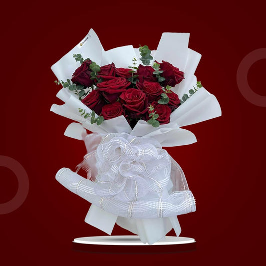 Angelic Dreamland bouquet with 12 red Ecuadorian roses and eucalyptus baby blue wrapped in white paper with mesh net accents