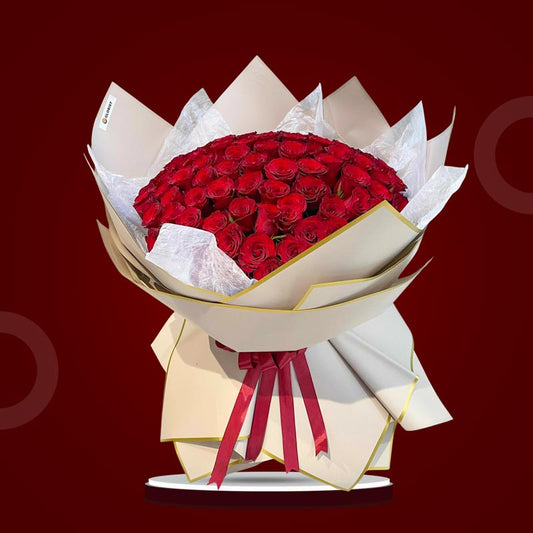 Appreciated Flora bouquet with 100 red China roses wrapped in dirty pink bordered Korean paper and tied with a maroon ribbon