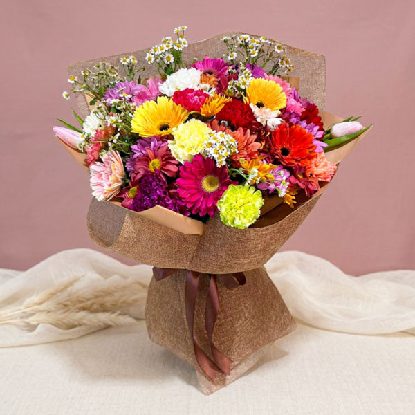 Colorful bouquet with gerberas, carnations, tulips, mums, and egg asters