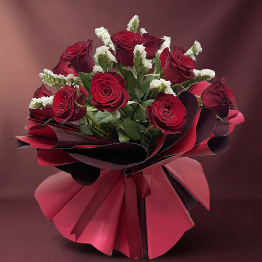 Aurora Flora bouquet with 12 red China roses and white statice wrapped in maroon and wine red Korean paper with maroon ribbon