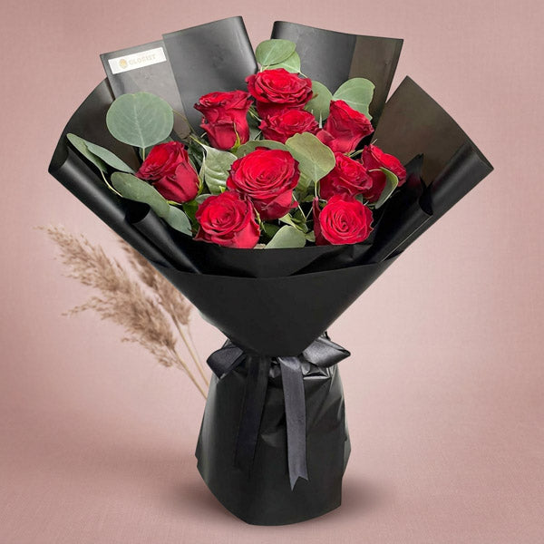 Bloom Flora bouquet with 10 red China roses and eucalyptus silver dollar in black Korean wrap with black ribbon