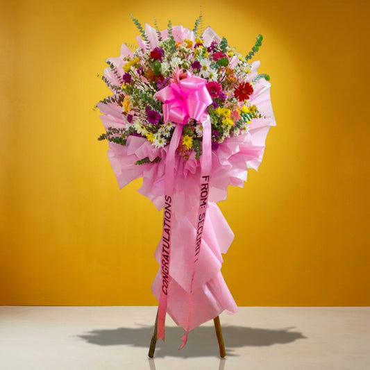 Blooming Launch Inaugural Stand with assorted gerbera daisies and eucalyptus fillers