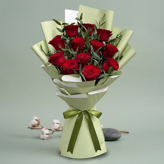 Brilliant Flora bouquet with 12 red China roses and eucalyptus parvi wrapped in matcha Korean paper and tied with a dark olive ribbon