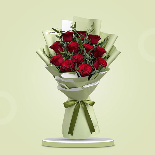 Brilliant Flora bouquet with 12 red China roses and eucalyptus parvi wrapped in matcha Korean paper and tied with a dark olive ribbon