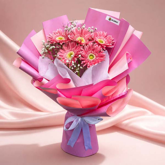 Charming Adoration bouquet featuring 5 light pink gerbera daisies with gypsophila baby’s breath