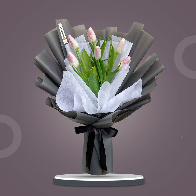 Chic Perennial bouquet with six light pink tulips in dark gray and white wraps tied with black ribbon