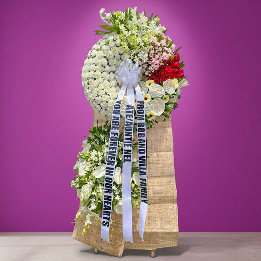 Clouds Memory Funeral Stand with white and pink carnations, red roses, orchids, anthurium, and white gerbera daisies