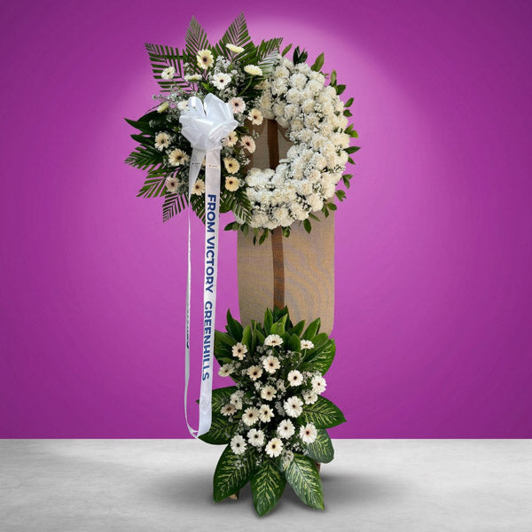 White carnation and gerbera funeral stand with asters and greenery