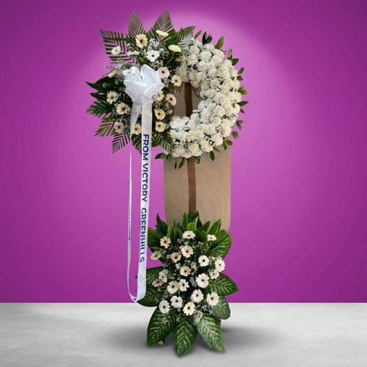 White carnation and gerbera funeral stand with asters and greenery