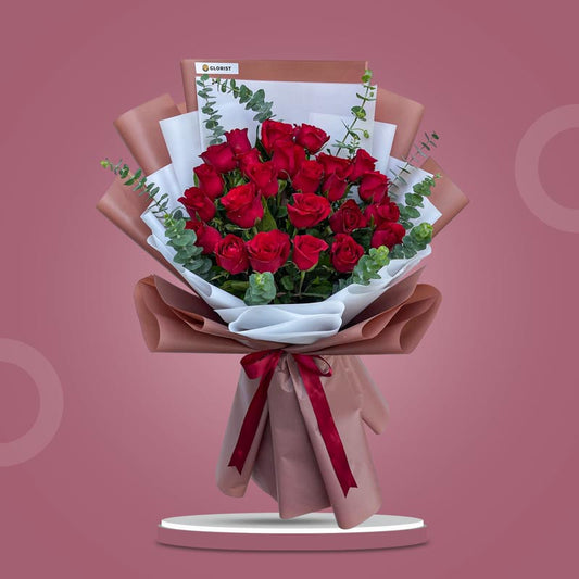 Creative Dreams bouquet with 24 red Philippine roses and eucalyptus baby blue in bean brown and white Korean wrap with maroon ribbon
