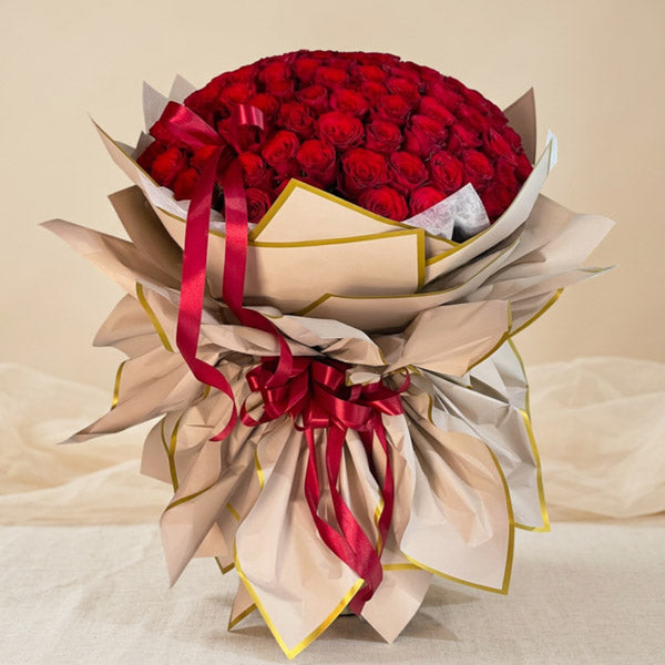 Curated Flora Imported Rose Flower Bouquet with 120 imported red China roses wrapped in dirty pink Korean wrap with gold border for flower delivery in Metro Manila
