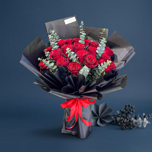 Dazzling Flora bouquet with 18 red China roses and eucalyptus baby blue, wrapped in black Korean paper with red ribbon — same-day delivery Manila