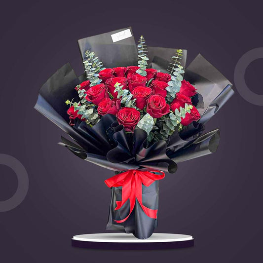 Dazzling Flora bouquet with 18 red China roses and eucalyptus baby blue, wrapped in black Korean paper with red ribbon — same-day delivery Manila