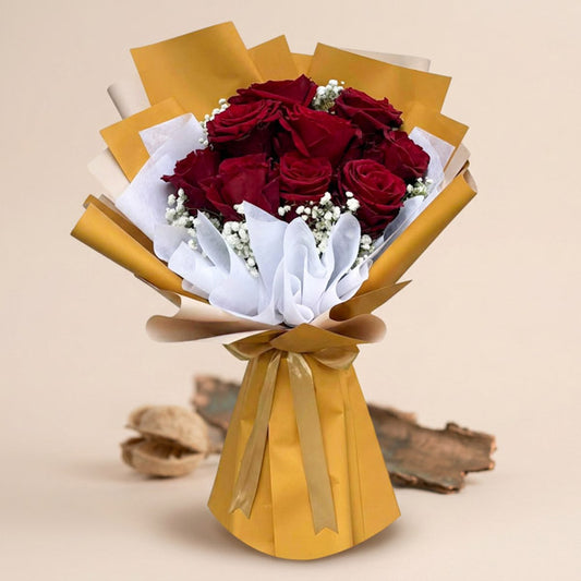 Decent Dreamland bouquet with 9 red Ecuadorian roses and gypsophila wrapped in mustard yellow and white paper, tied with a light gold ribbon