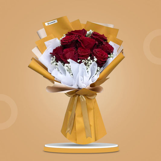 Decent Dreamland bouquet with 9 red Ecuadorian roses and gypsophila wrapped in mustard yellow and white paper, tied with a light gold ribbon