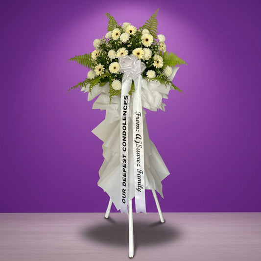 Dignified Memory Flower Stand with white gerbera daisies, white wonder mums, and egg asters arranged for a solemn funeral tribute