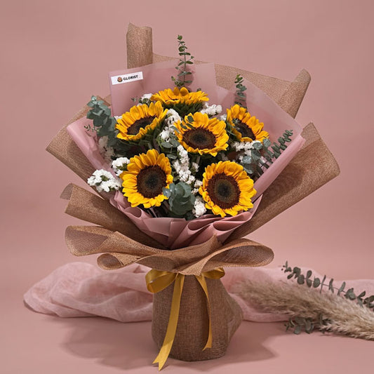 Echo Summer bouquet with sunflowers, eucalyptus baby blue, and white statice arranged by Glorist Manila