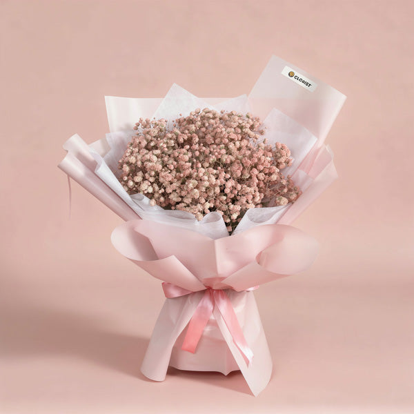 Exciting Snow bouquet with light pink painted Gypsophila Baby’s Breath in light pink and white wrap with pink ribbon