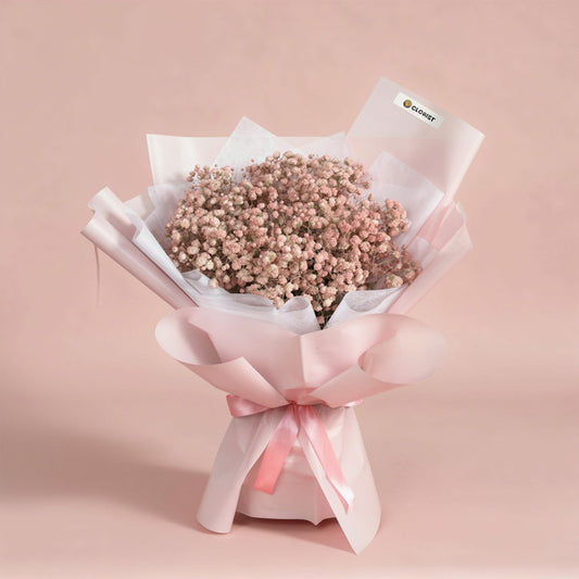 Exciting Snow bouquet with light pink painted Gypsophila Baby’s Breath in light pink and white wrap with pink ribbon