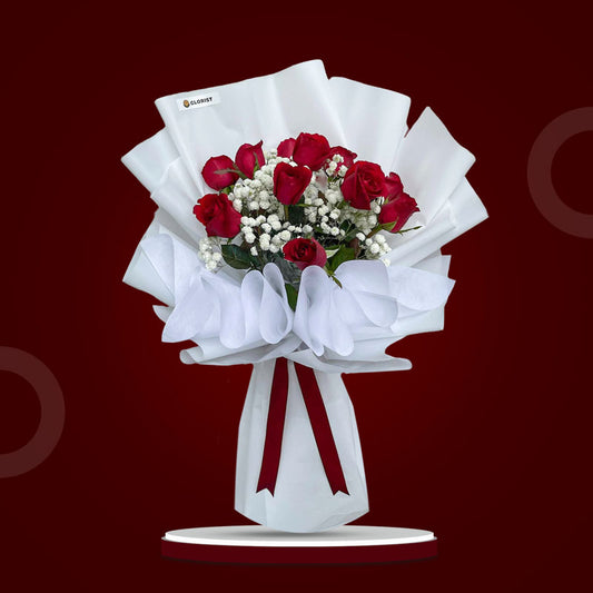 Fanciful Dreams bouquet with 12 red Philippine roses and gypsophila in full white wrap with maroon ribbon