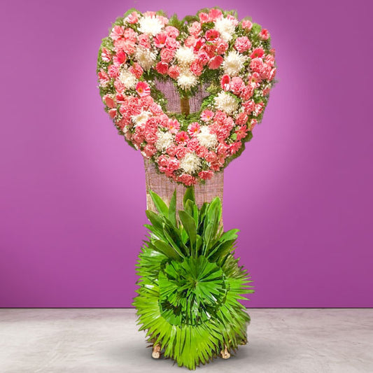 Flame Memory Funeral Stand with chrysanthemums, pink carnations, pink gerbera daisies, white roses, eucalyptus, and anahaw leaves