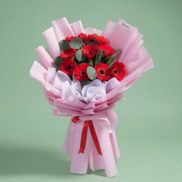 Genuine Adoration bouquet with 10 red Gerbera daisies and Eucalyptus Silver Dollar in light violet wrap with red ribbon