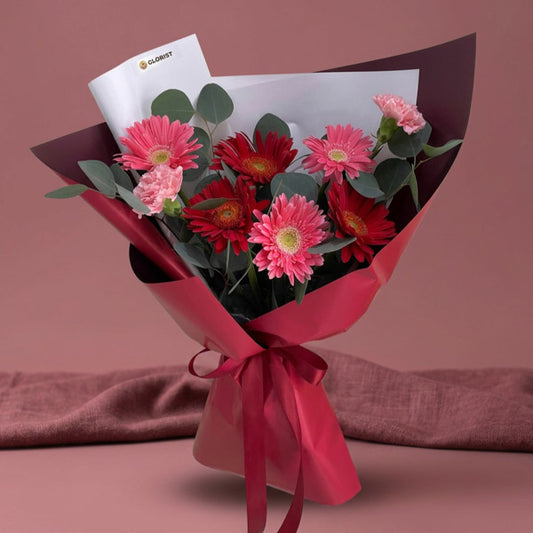 Light pink and red gerbera bouquet with carnations and eucalyptus fillers
