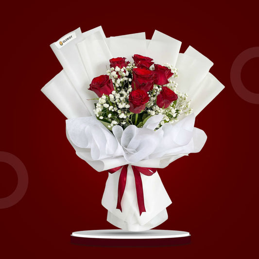 Glossy Flora Flower Bouquet with seven red China roses and baby’s breath wrapped in white Korean and non-woven wrap, tied with a maroon ribbon