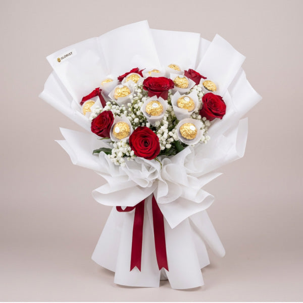 Graceful Sweets Chocolate Bouquet with 12 Ferrero Rocher chocolates and 7 red China roses wrapped in white Korean paper with maroon ribbon, same-day delivery in Metro Manila