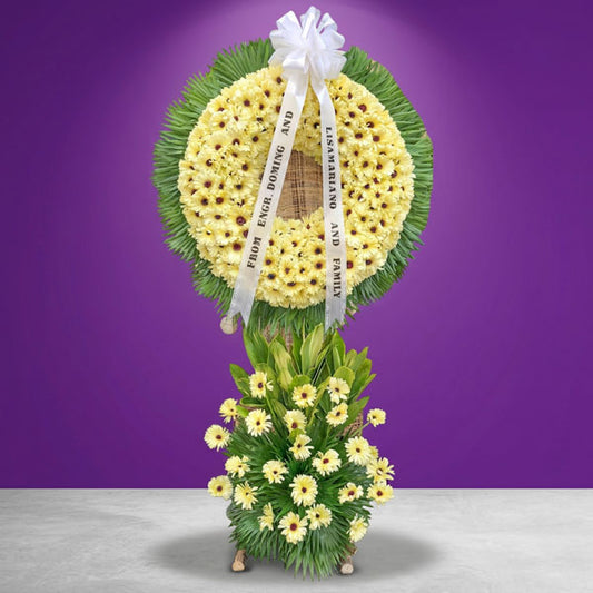 Infinite Memory Wreath Stand with yellow gerbera daisies and anahaw leaves, funeral floral tribute