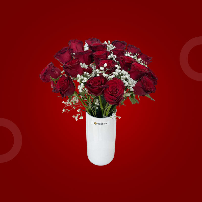 Knightly Fresh Flower Vase with twenty red China roses and two sets of baby’s breath in a clear glass vase