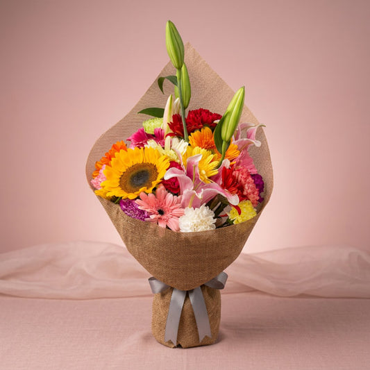 Lavish Love Flower Bouquet with assorted carnations, gerberas, sunflower, and stargazer lily in Chinese burlap wrap for flower delivery in Metro Manila