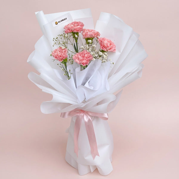 Light pink carnations with gypsophila baby's breath wrapped in white Korean paper, a soft everyday and get-well flower gift with same-day Metro Manila delivery