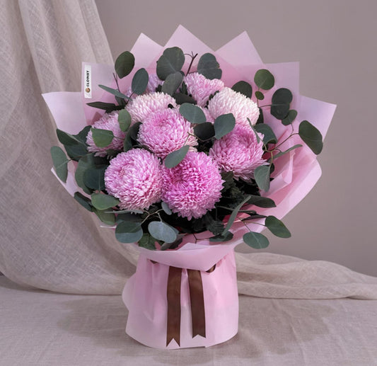Light pink sunlight flowers bouquet with eucalyptus fillers and Korean-style wrapping