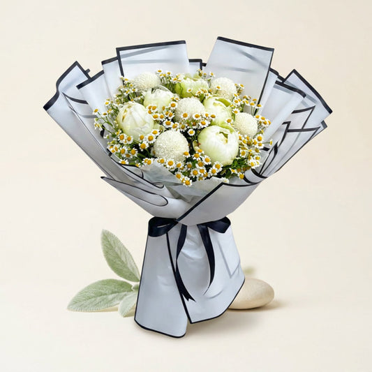Lumen Fusion bouquet with white peonies, white pompoms, and egg asters wrapped in white Korean paper with black border and black ribbon