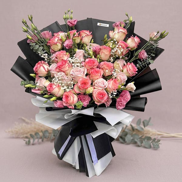 Luxury bouquet with light pink roses, lisianthus, baby’s breath, and eucalyptus fillers