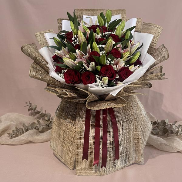 Luxury bouquet with red Ecuadorian roses, stargazer lilies, and baby’s breath fillers
